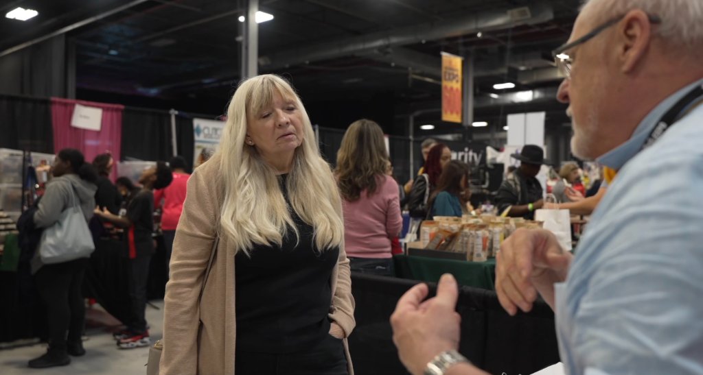Capt. Robert Polakoski speaking with an attendee at the Ultimate Women's Expo