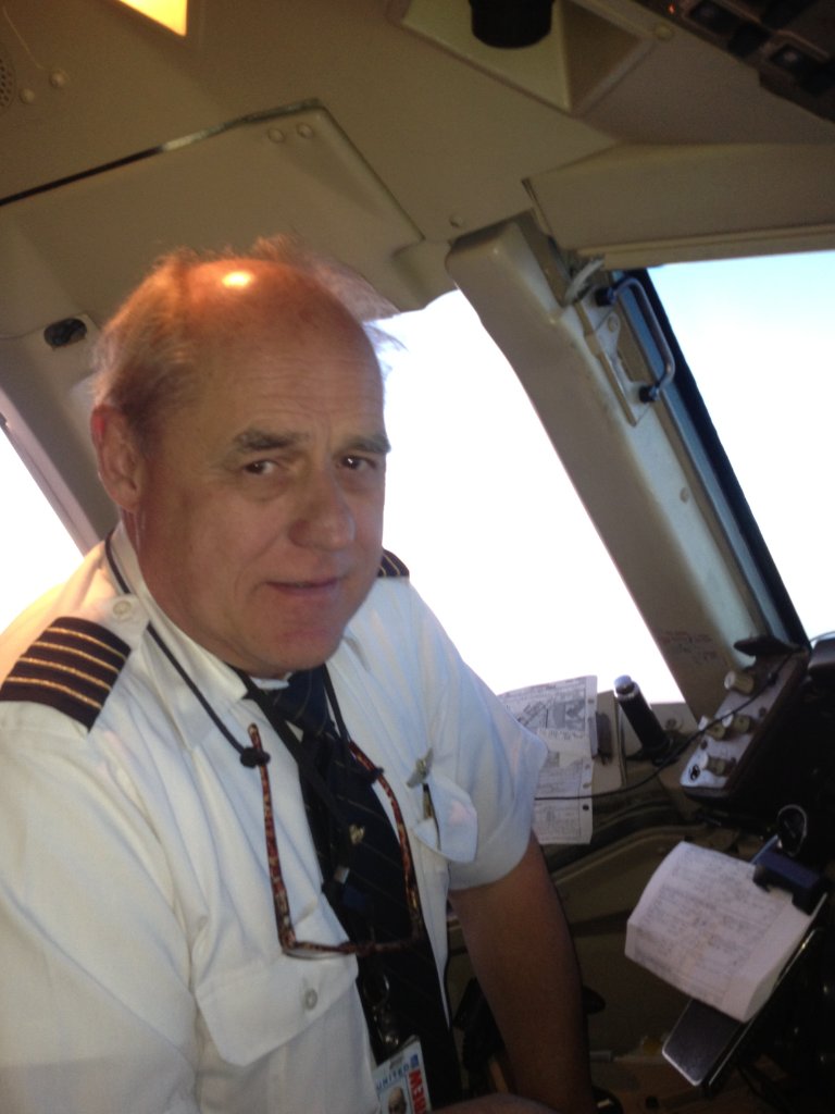 Capt. Robert Polakoski in the cockpit of a commercial airliner in uniform