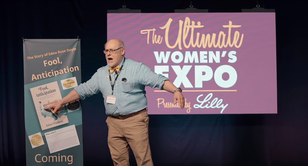 Capt. Robert Polakoski speaking on stage at the Ultimate Women's Expo