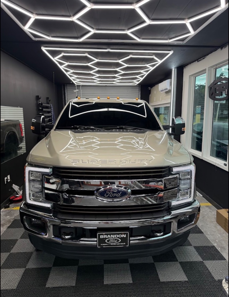Ford Super Duty truck in Got Tint workshop with hex lighting