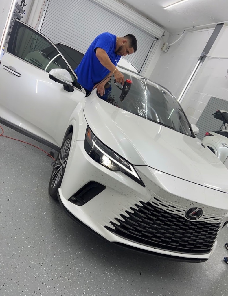 Technician applying window tint on Lexus at Got Tint
