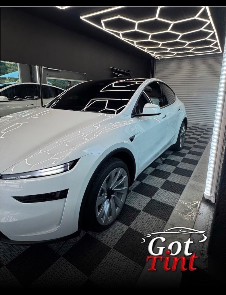 White Tesla with dark tinted windows in Got Tint studio