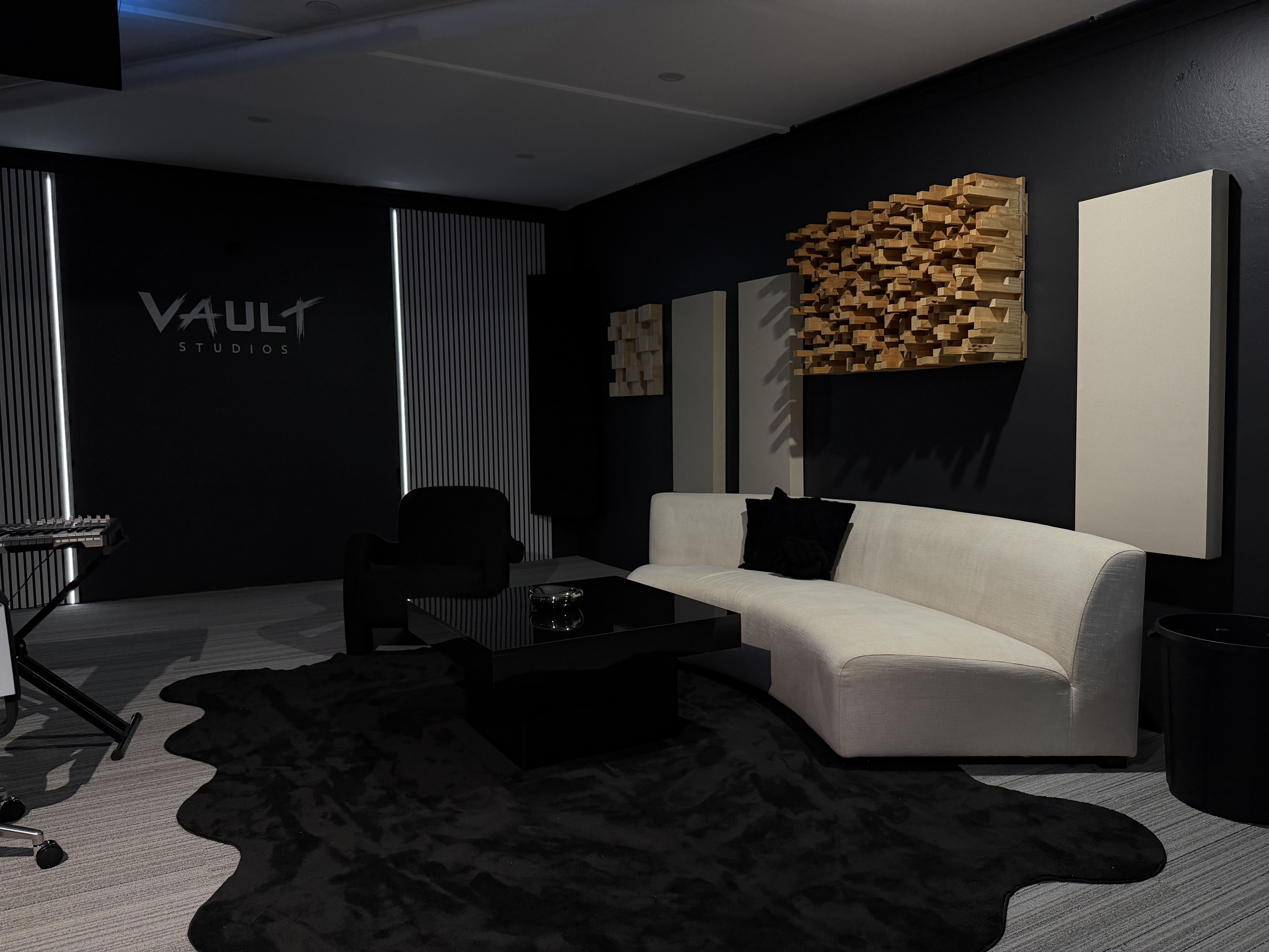 VAULT Studios lounge with white curved couch and diffusers