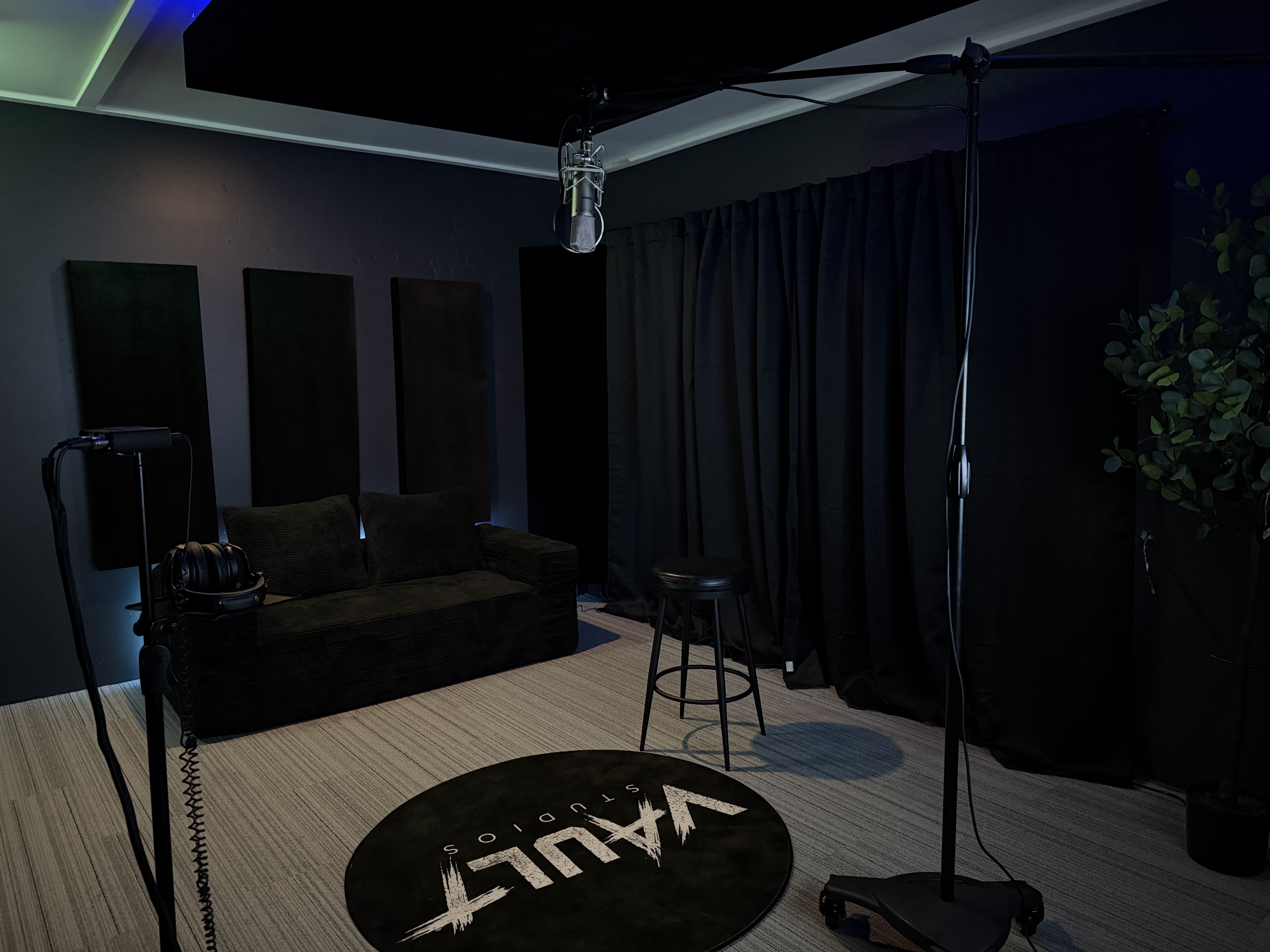 Recording booth with VAULT rug, couch and vocal mic