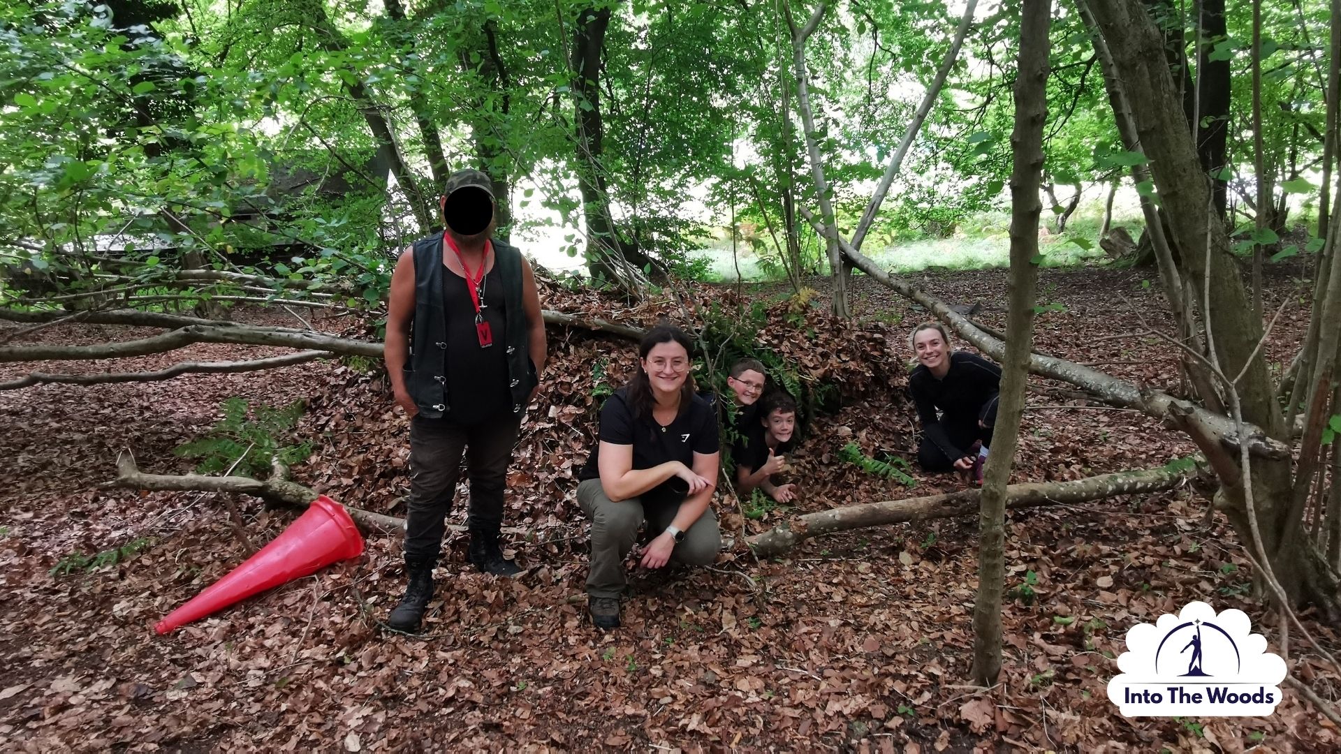 Shelter Building Kent - participants inside a completed woodland shelter