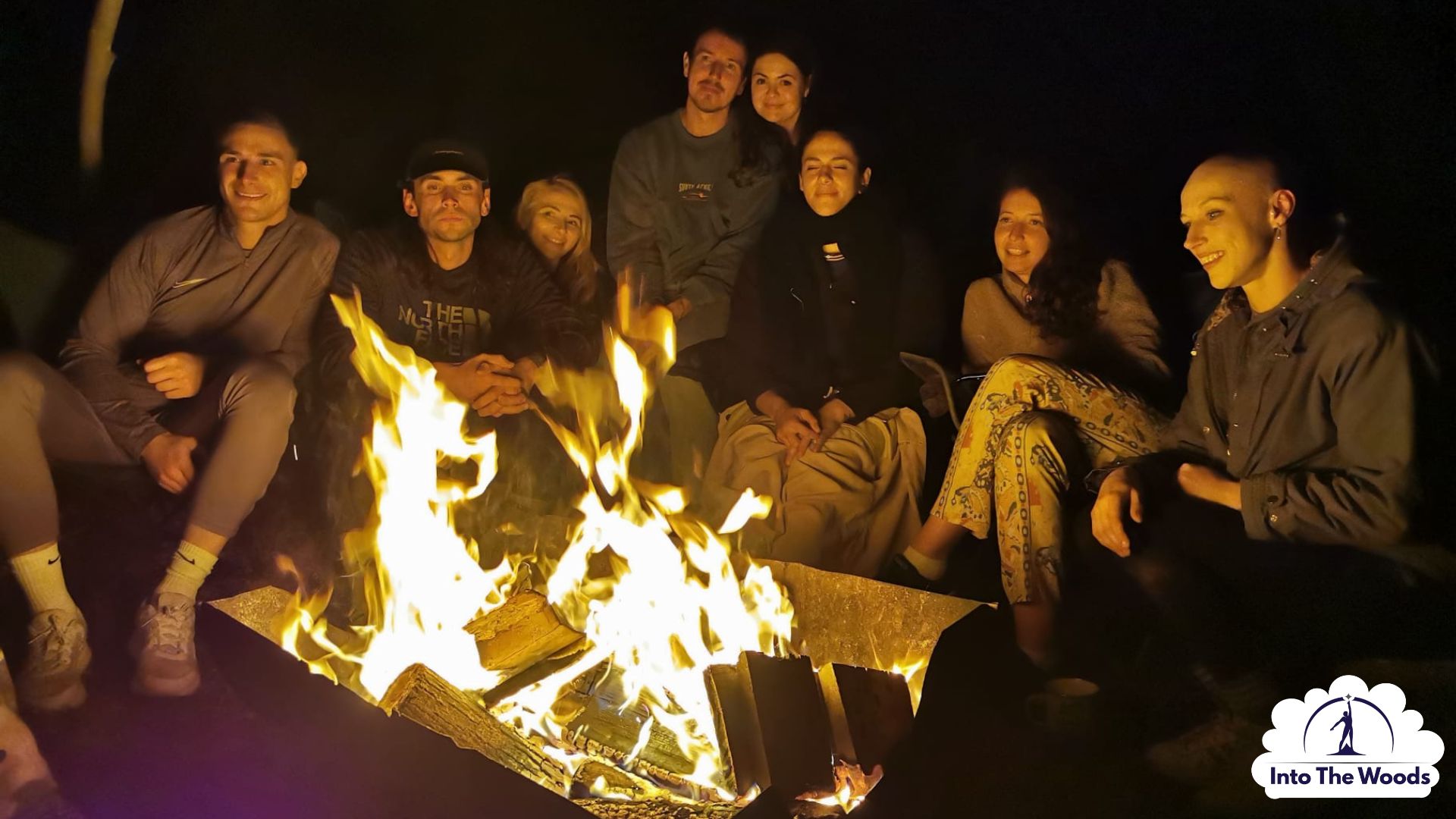 Campfire Experience Kent - group around fire at night in woodland