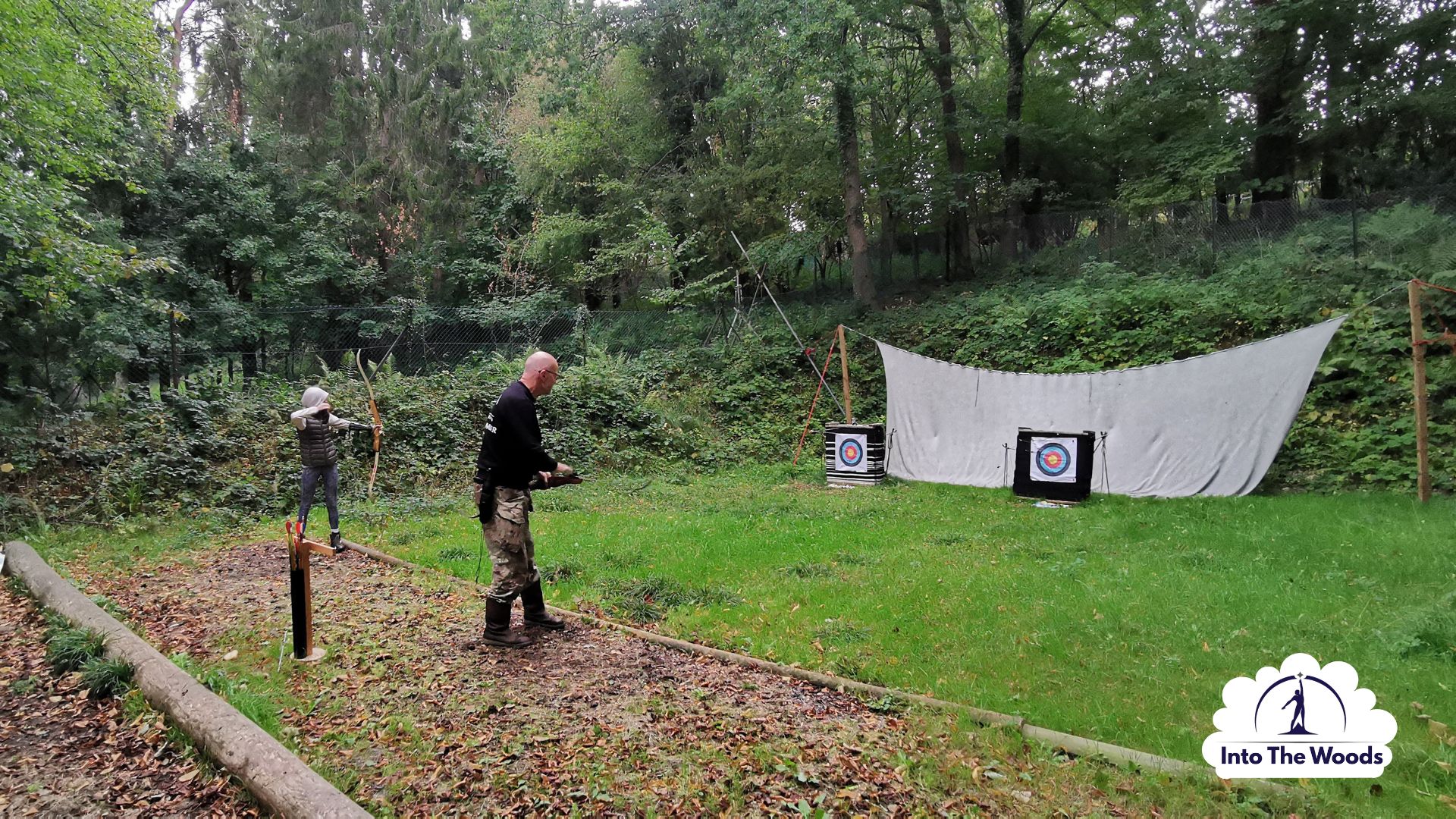 Archery team building Kent - corporate group working together in woodland