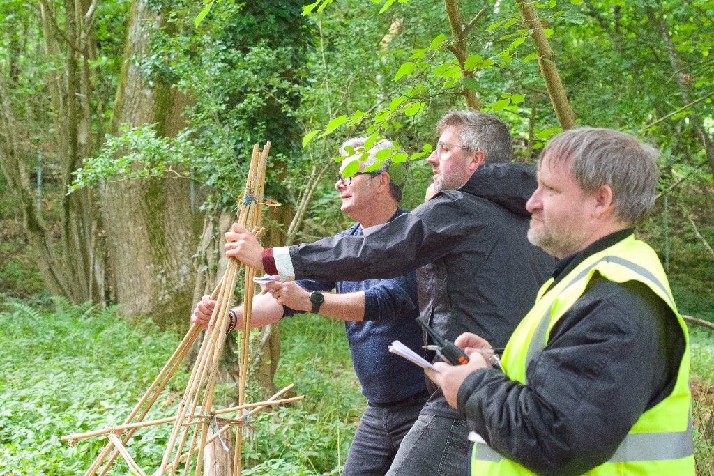 Into The Woods participants building structures in woodland