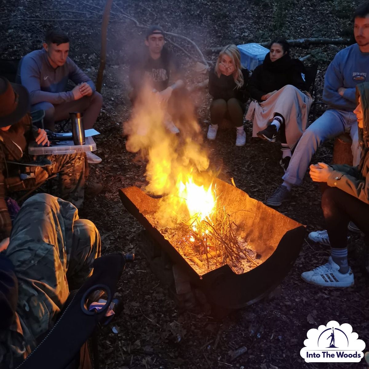 Poetry and Creative Writing Kent - group around campfire with guitar in woodland