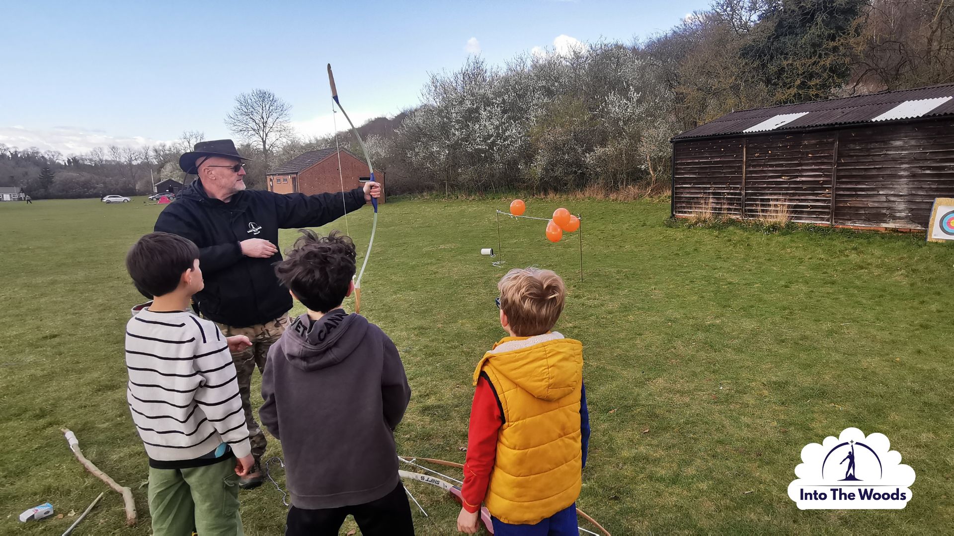Archery Kent - instructor guiding participant at archery range in woodland