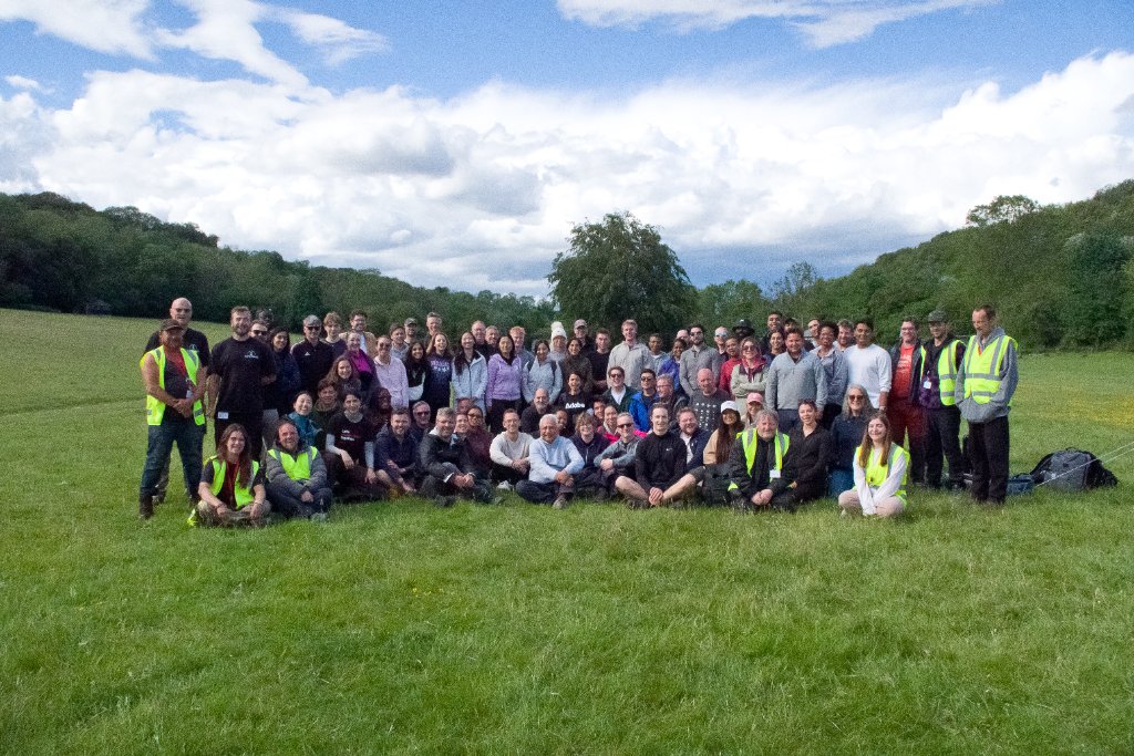 Adobe corporate event group photo - 73 delegates in woodland setting