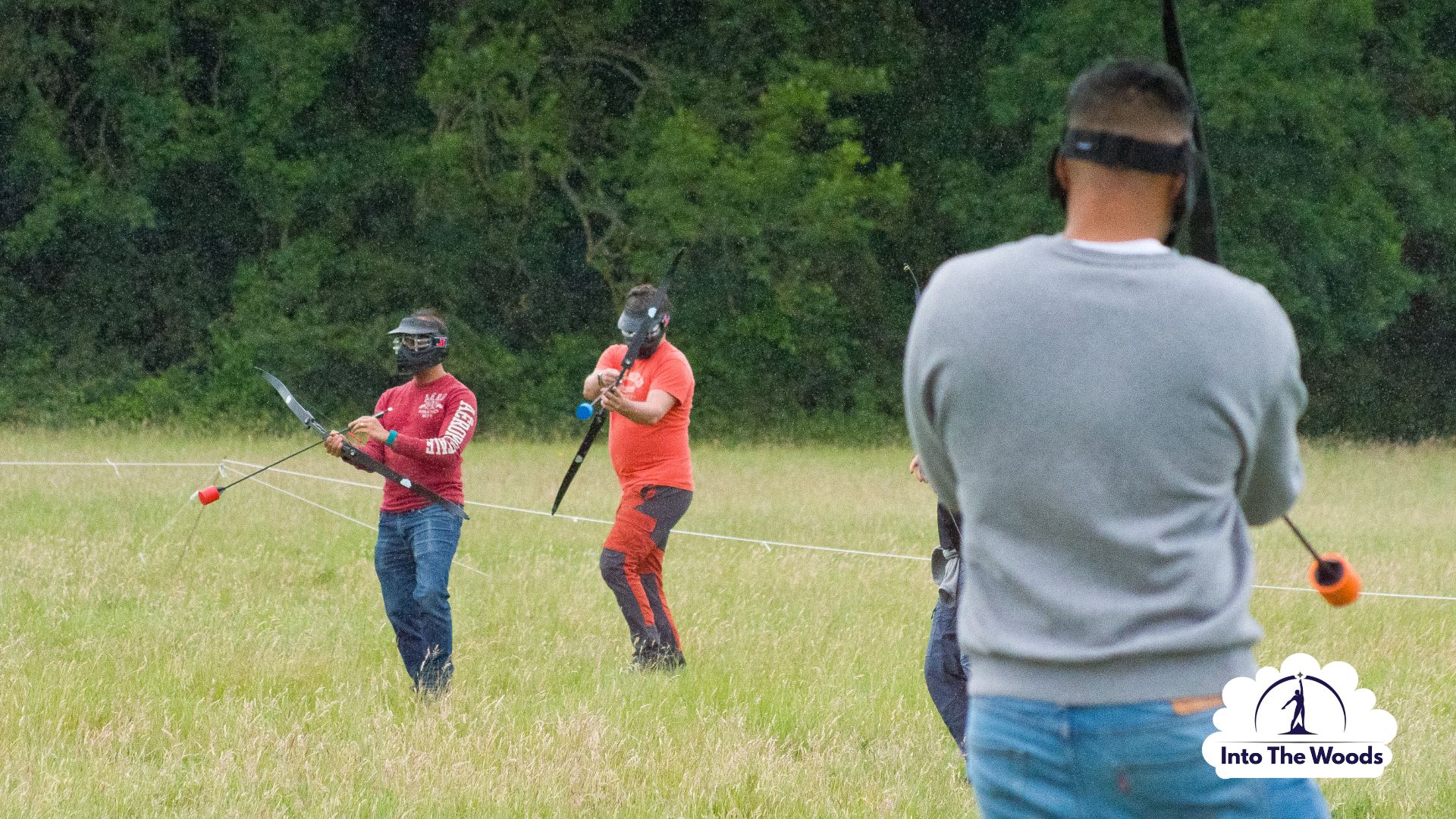 Archery Tag team building Kent - corporate group working together in woodland