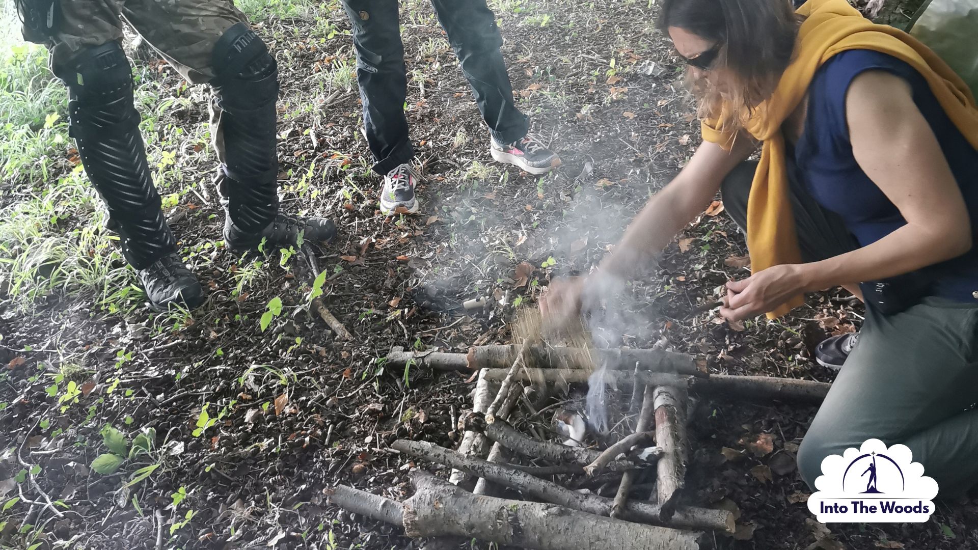 Fire Lighting Kent - group gathered around a newly lit campfire in woodland