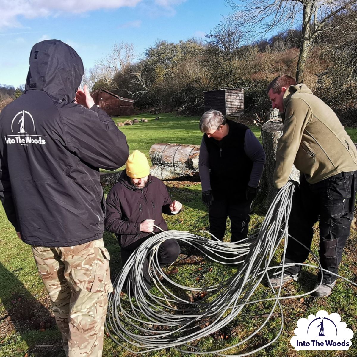 Command Tasks Kent - group working with rope and knots on woodland floor