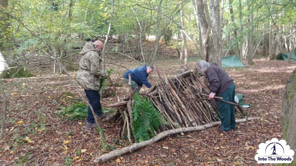 Shelter Building - group constructing debris shelter in woodland