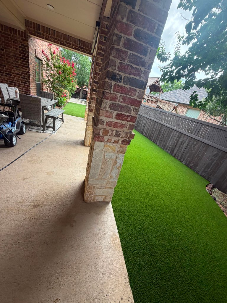 Covered patio overlooking a full artificial turf installation