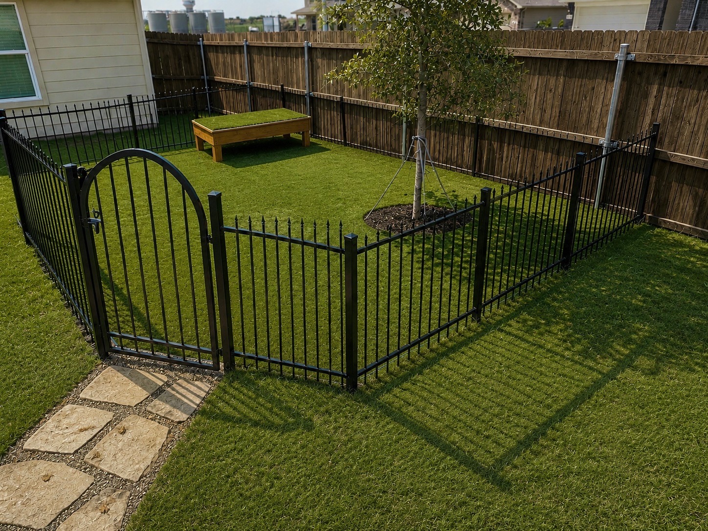 Custom dog run with engineered drainage and artificial turf