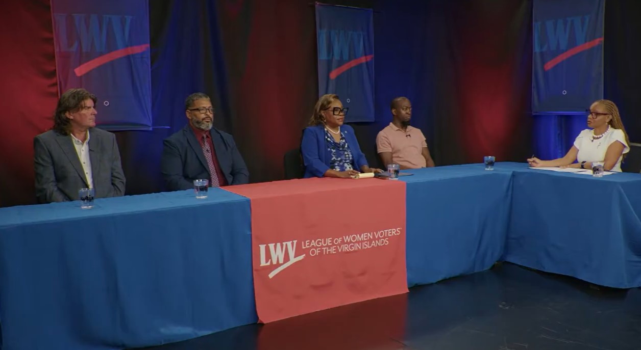 Four St. Thomas–St. John District Senate candidates seated at the discussion table during the WTJX Meet the Candidates forum, with League of Women Voters of the Virgin Islands signage visible.