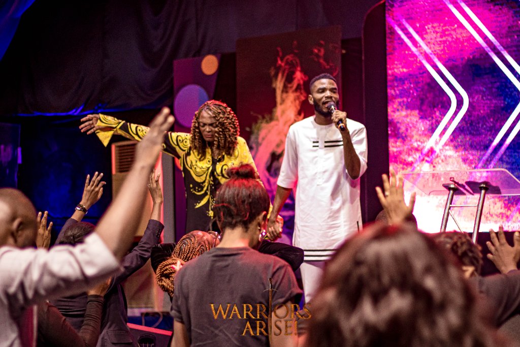 Warriors Arise 2024 — Soloist performing on stage in gold dress