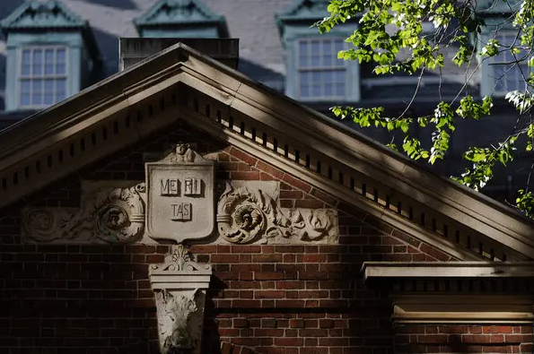 Architectural stone building bearing Veritas crest
