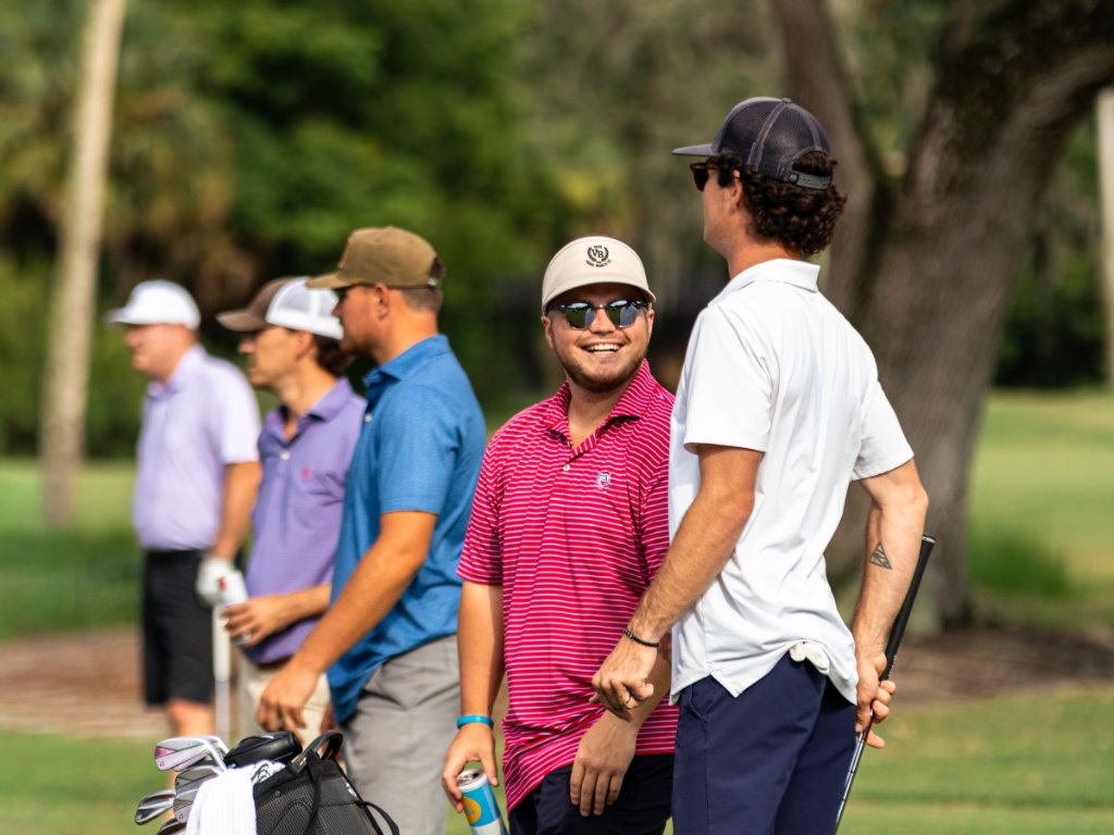 Group of golfers watching a shot at the tee box