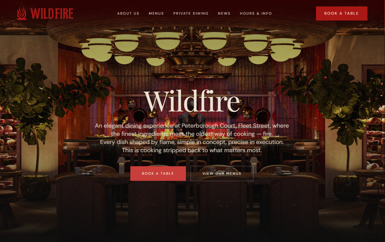 Wildfire restaurant website homepage featuring a moody open-flame kitchen scene.