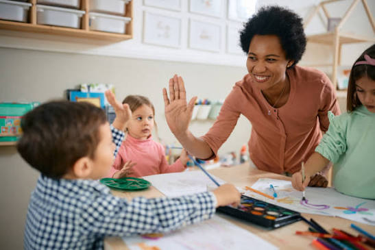 Teacher giving high-five to student in classroom