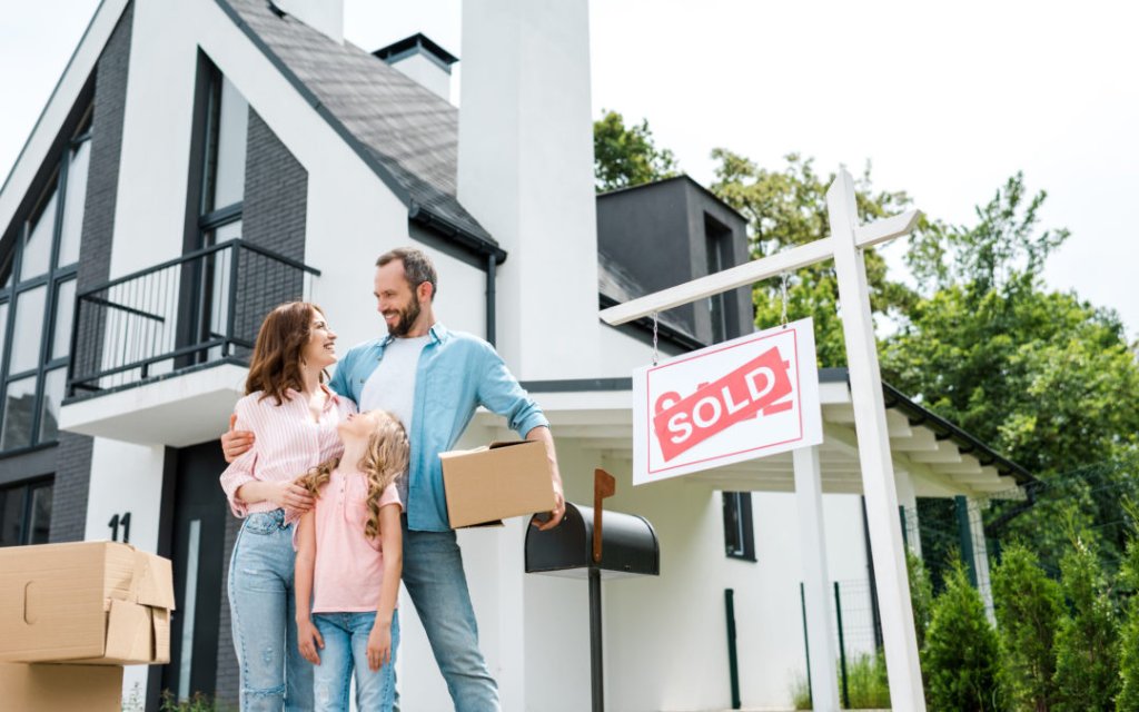 Family in front of sold home