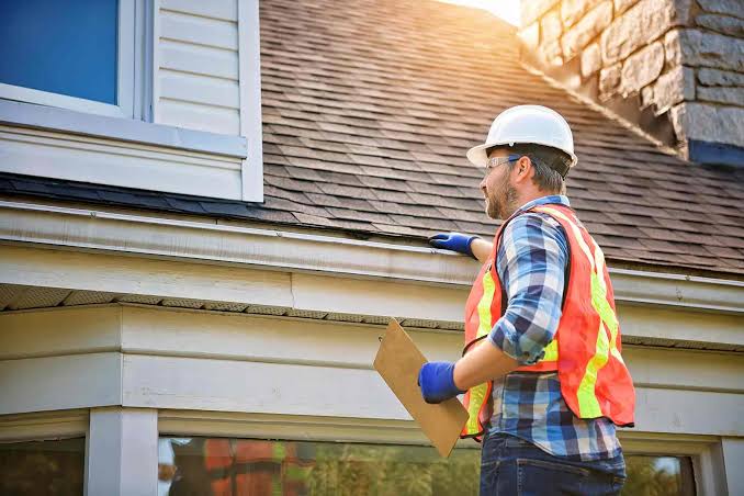 Roofer identifying issues on Utah home
