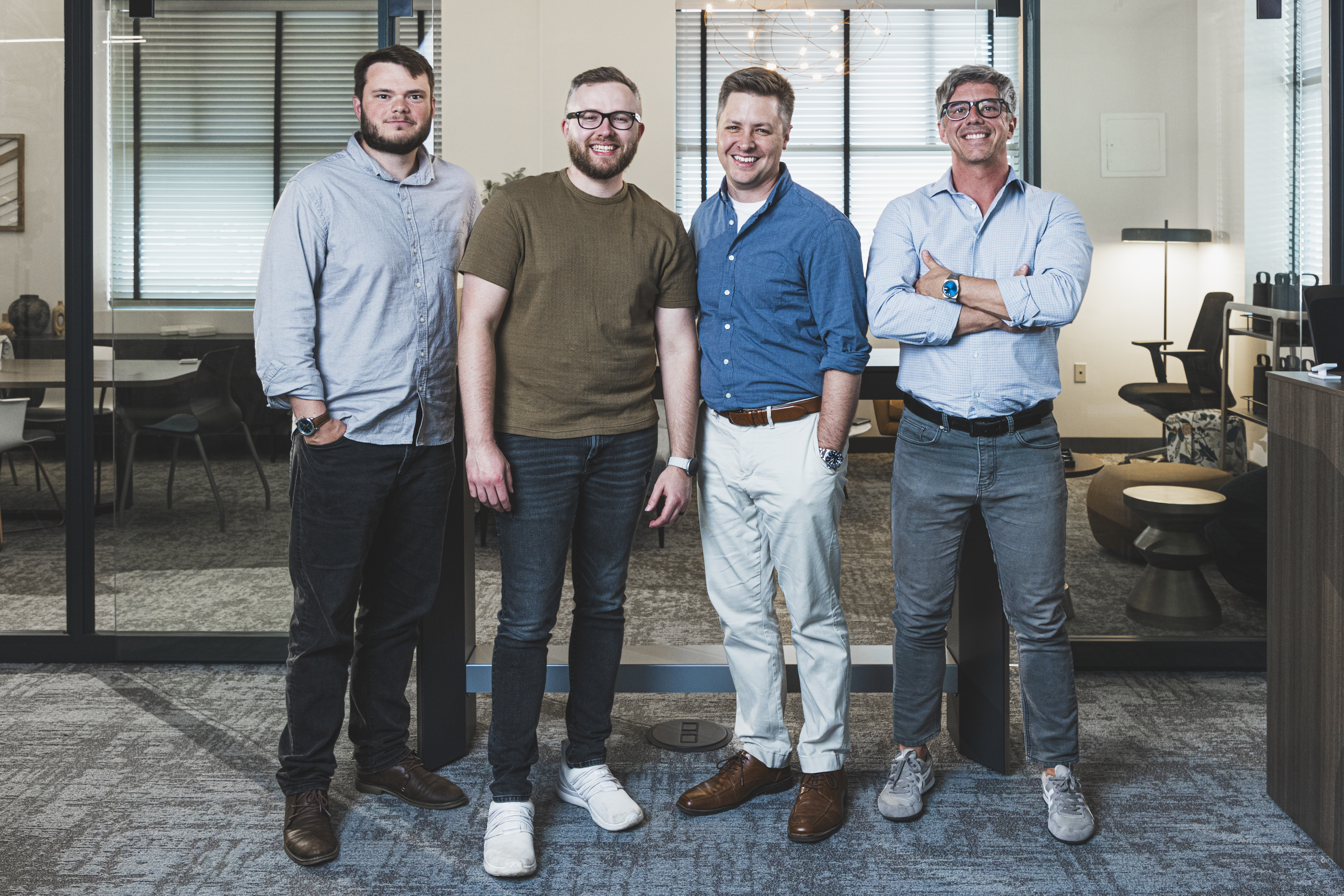 The Operations Guide team standing together in their office