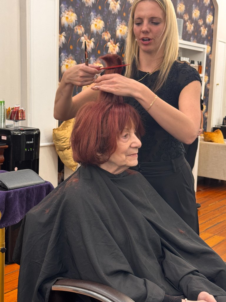 Shaina styling Arlene's custom hair topper at the salon