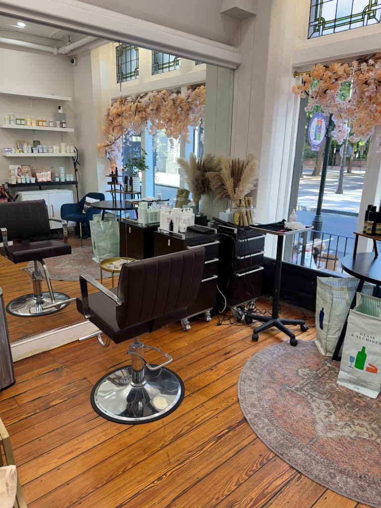 Pileggi on the Square salon interior with vintage styling chairs and floral decor