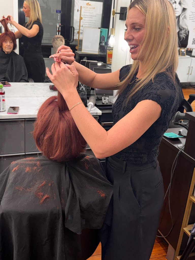 Shaina styling Arlene's custom hair topper at the salon