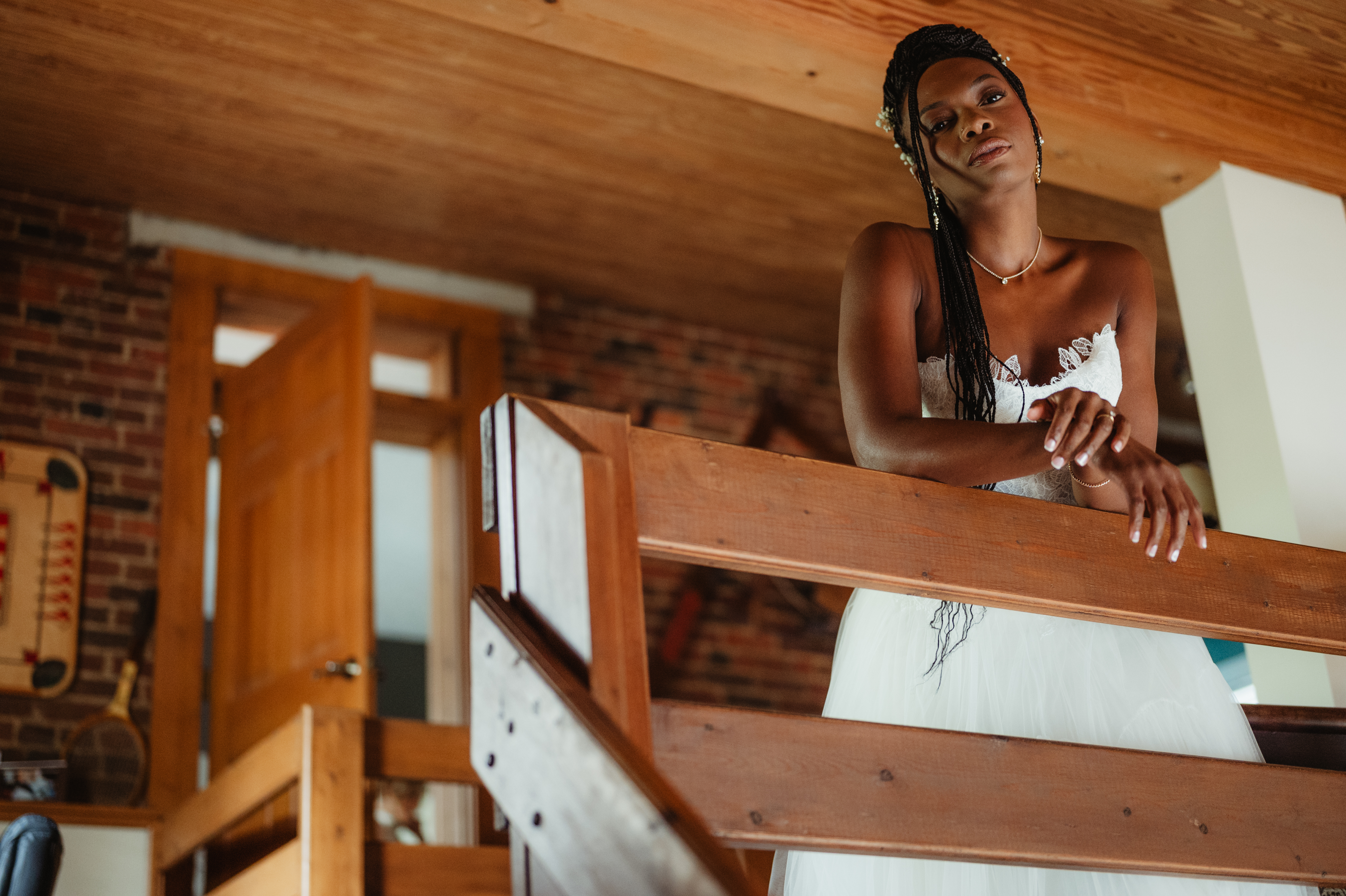 Bride leaning on a wooden railing