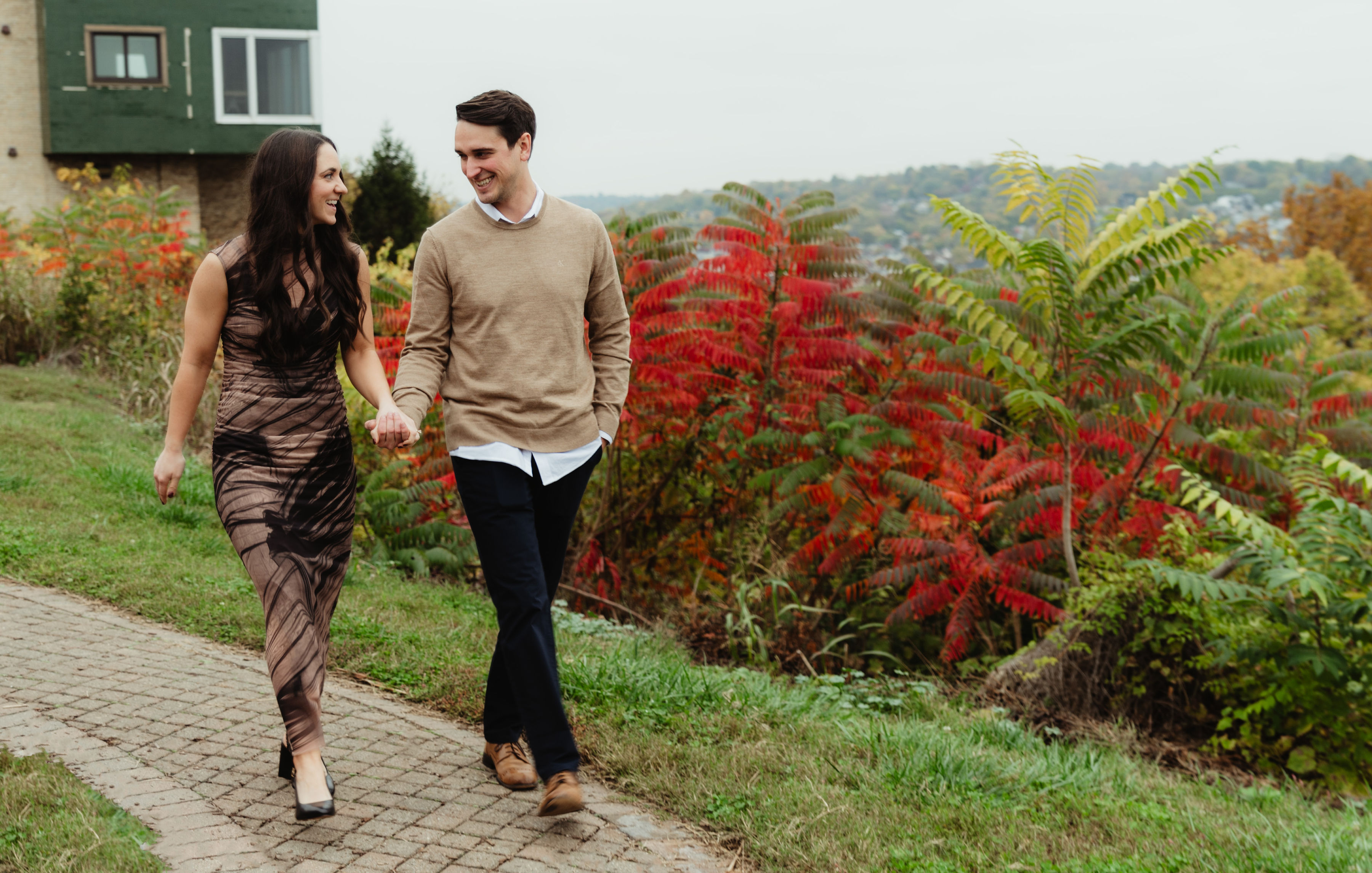Couple walking hand in hand along a stone path