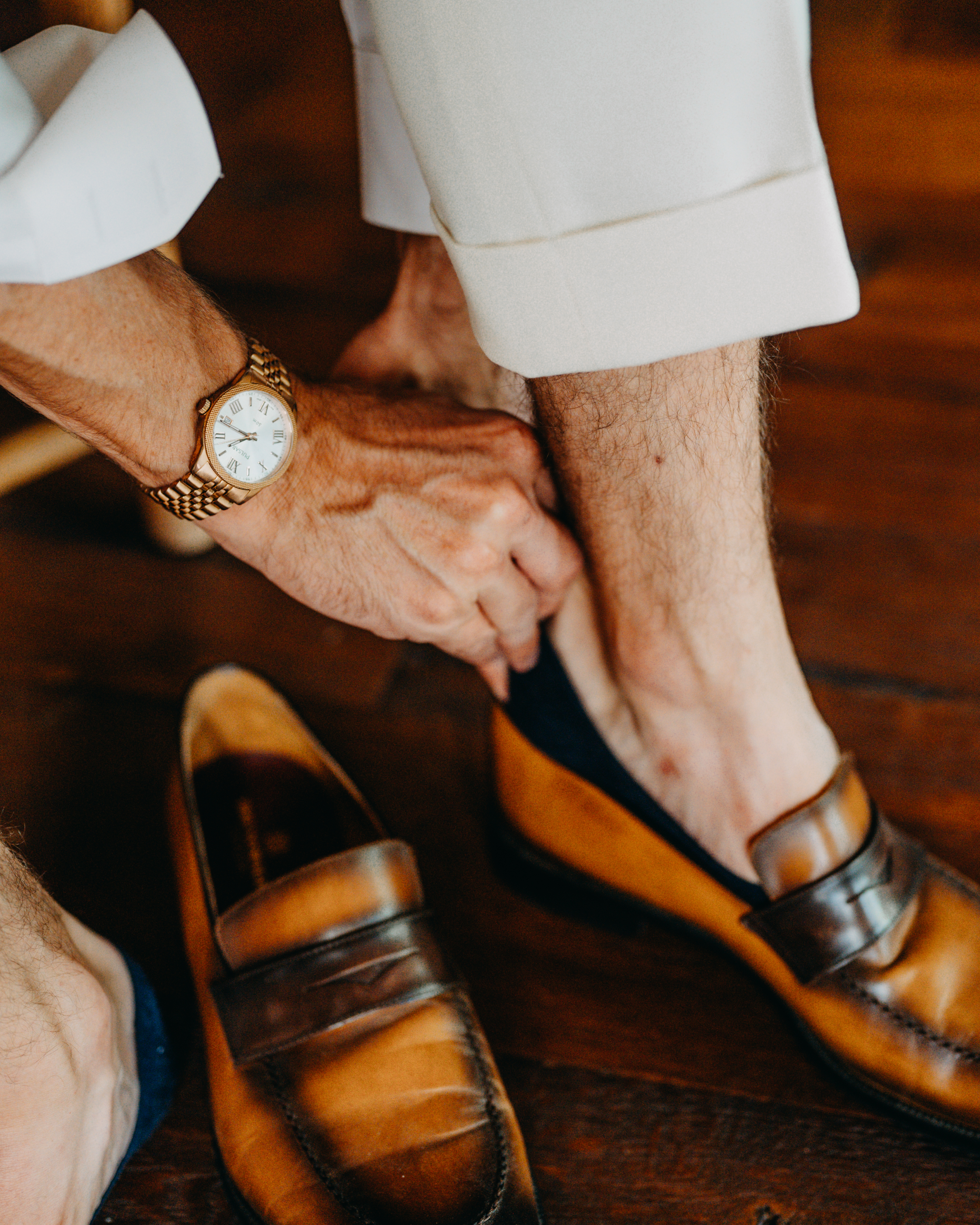 Groom getting ready with loafers and watch