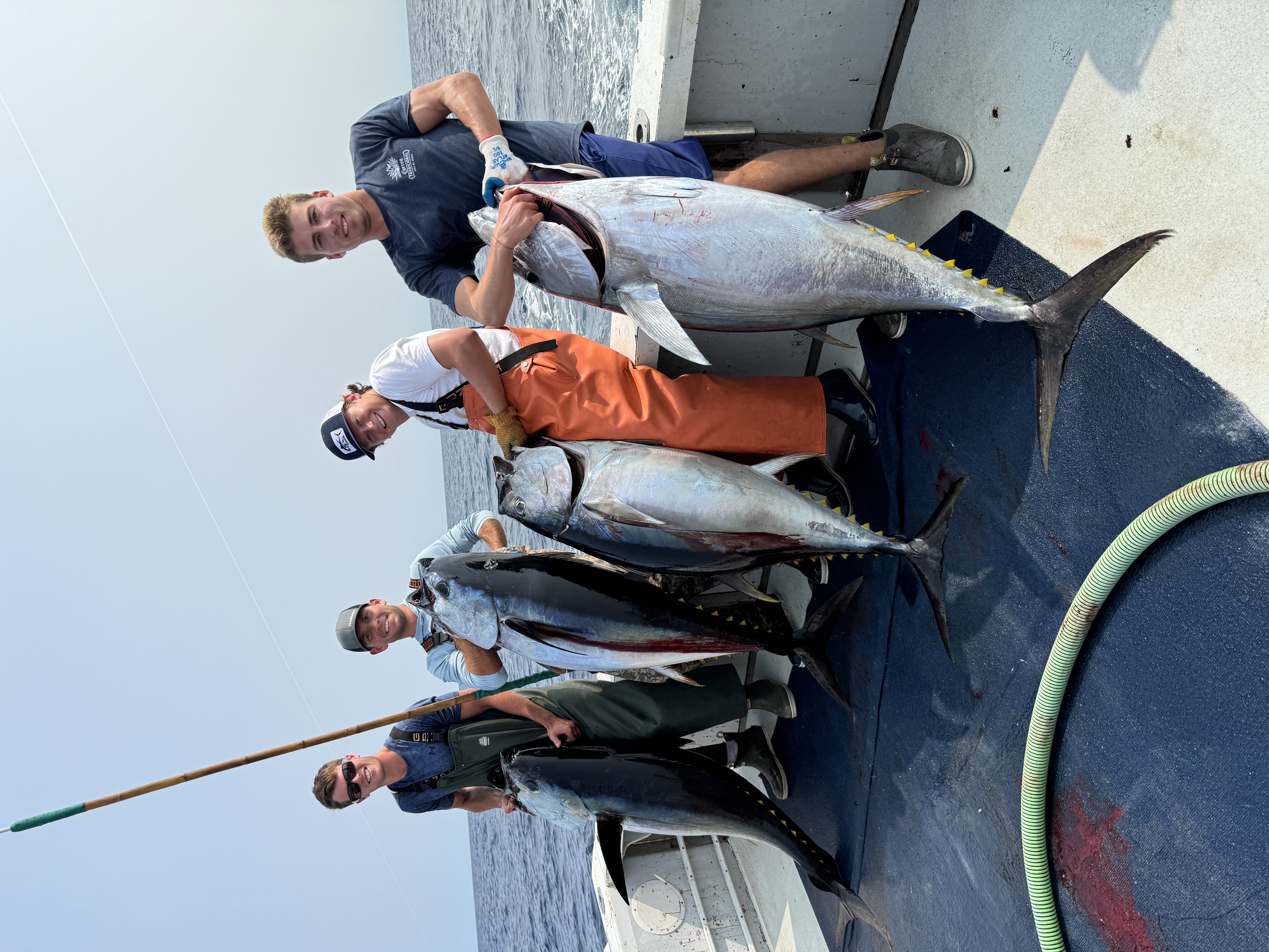 Crew with four yellowfin tuna catches