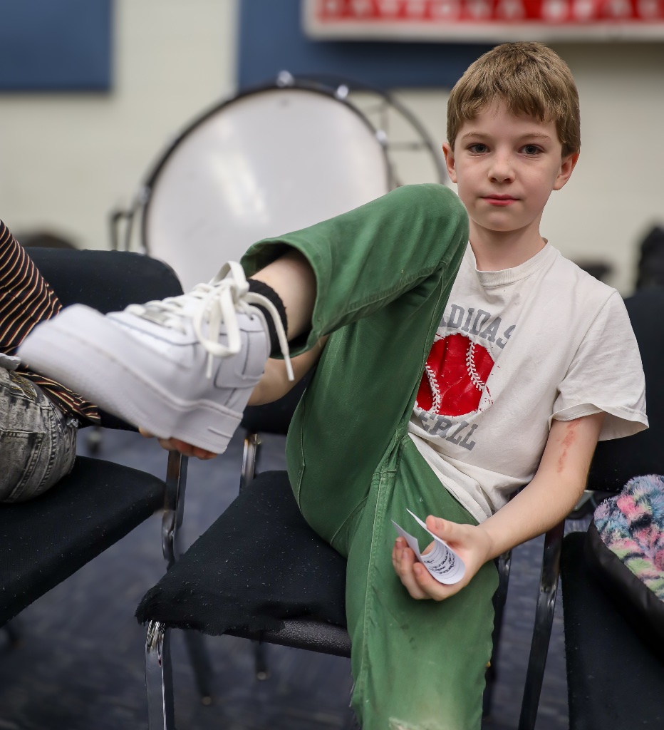 AduKicks Shoe Drive — child trying on new shoes
