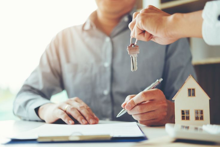 Handing over house keys at a real estate closing