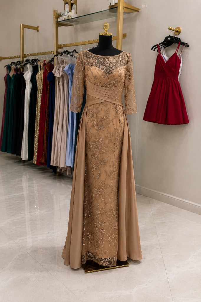 Champagne gold lace formal gown with three-quarter sleeves on dress form in boutique