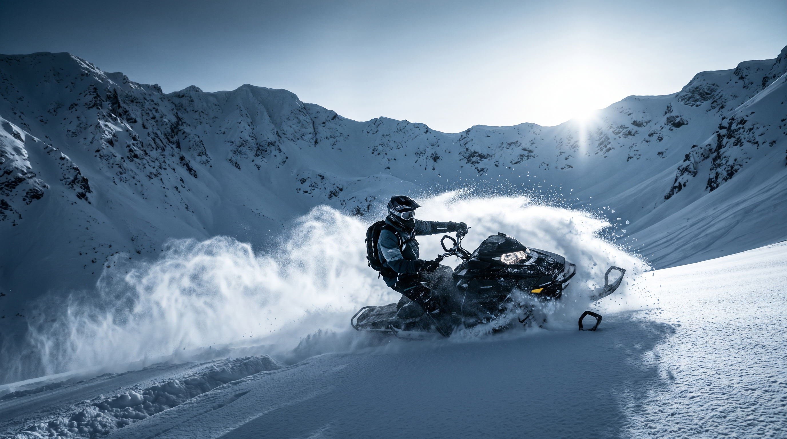 Snowmobile rider carving through deep powder in an alpine mountain bowl