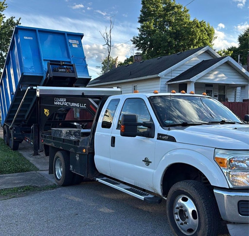 White Ford F-350 with blue dumpster on trailer