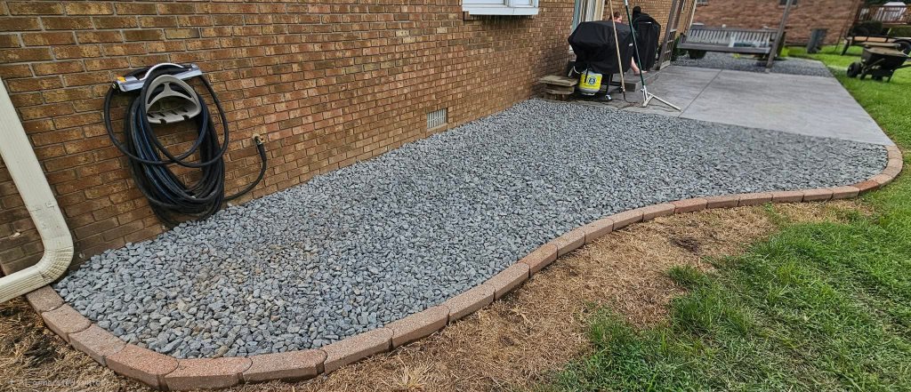 Crushed blue-grey stone flower bed with paver edging