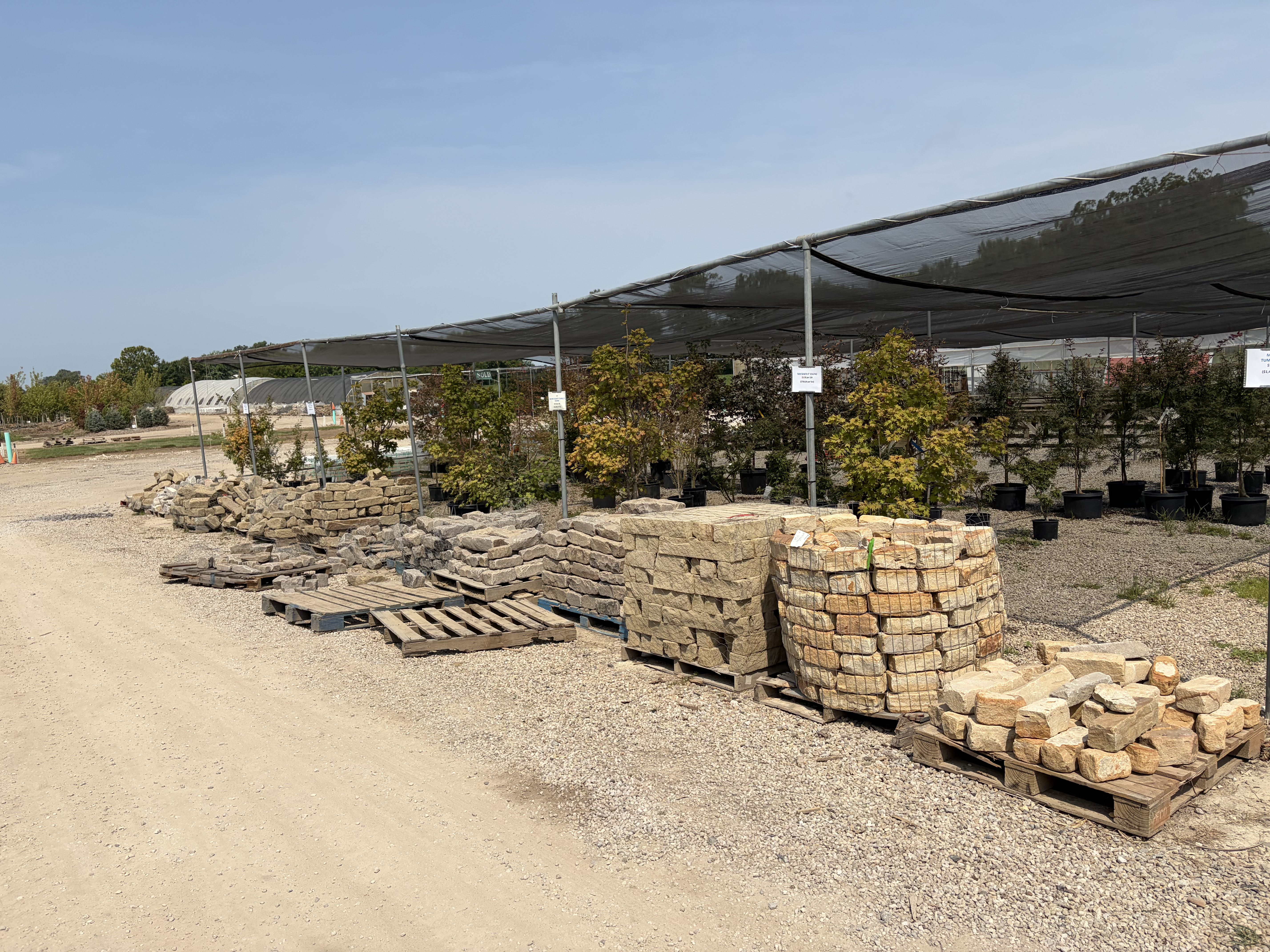 Flagstone & building stone pallets under shade canopy