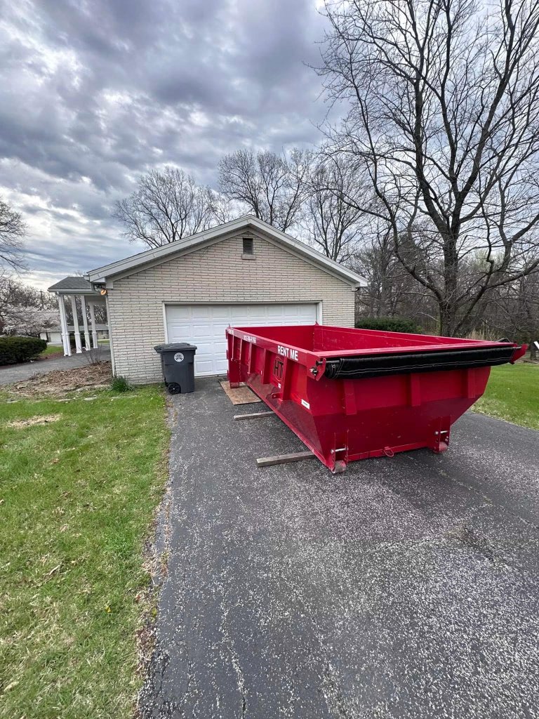 15-yard red roll-off dumpster on residential driveway