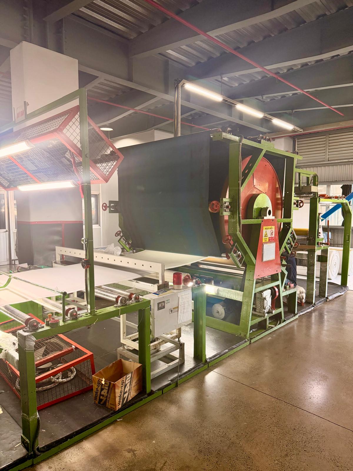 Industrial finishing machine processing material in the factory