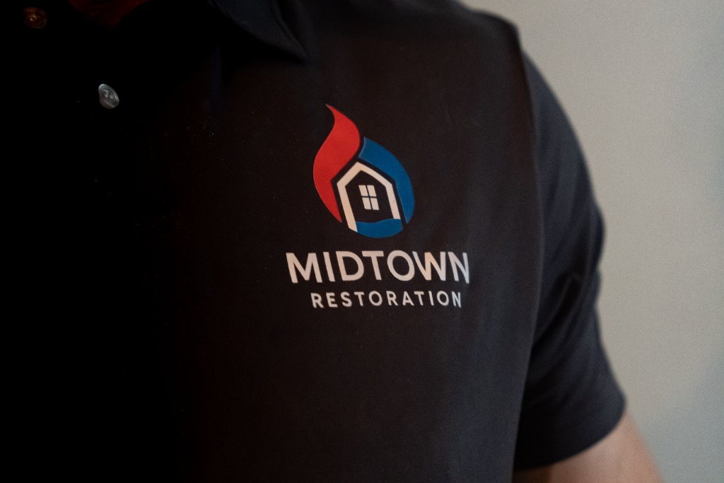 Midtown Restoration technician in branded uniform