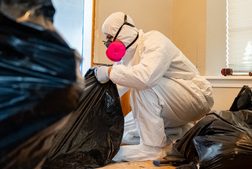 Technician in full protective gear during remediation