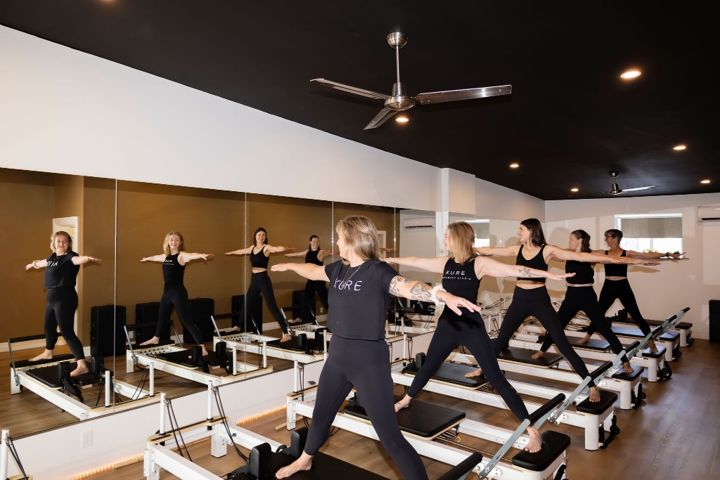 Women practicing on Pilates reformers at KURE MOVEMENT STUDIO