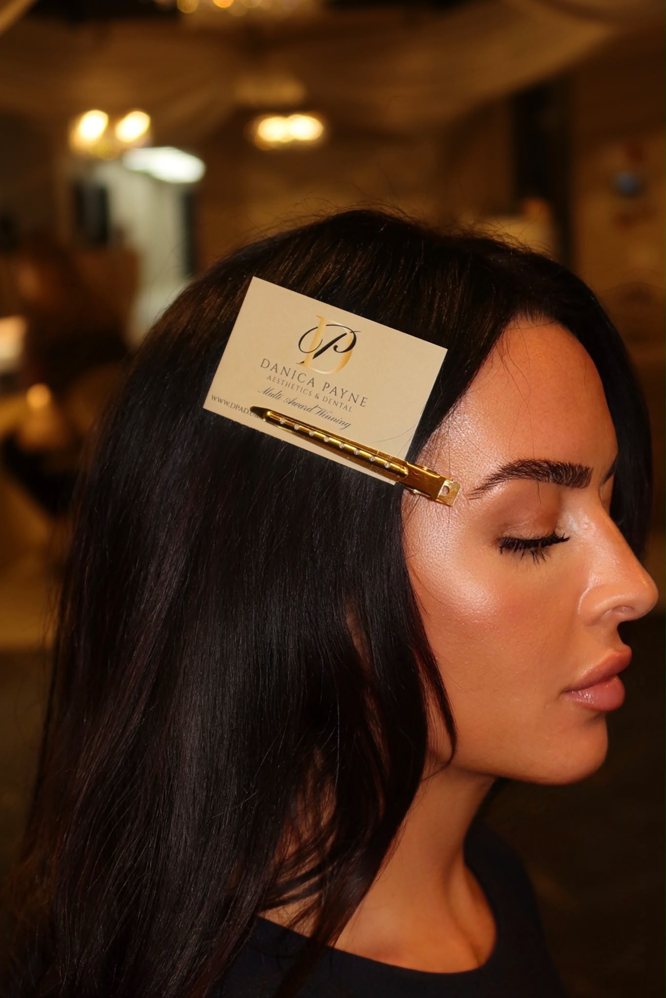 Danica Payne membership card clipped into glossy dark hair
